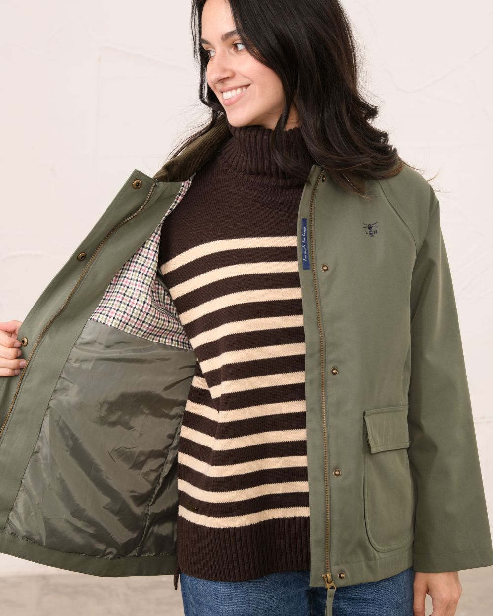 Olivine coloured Lighthouse Ladies Devon Raincoat on indoor background 