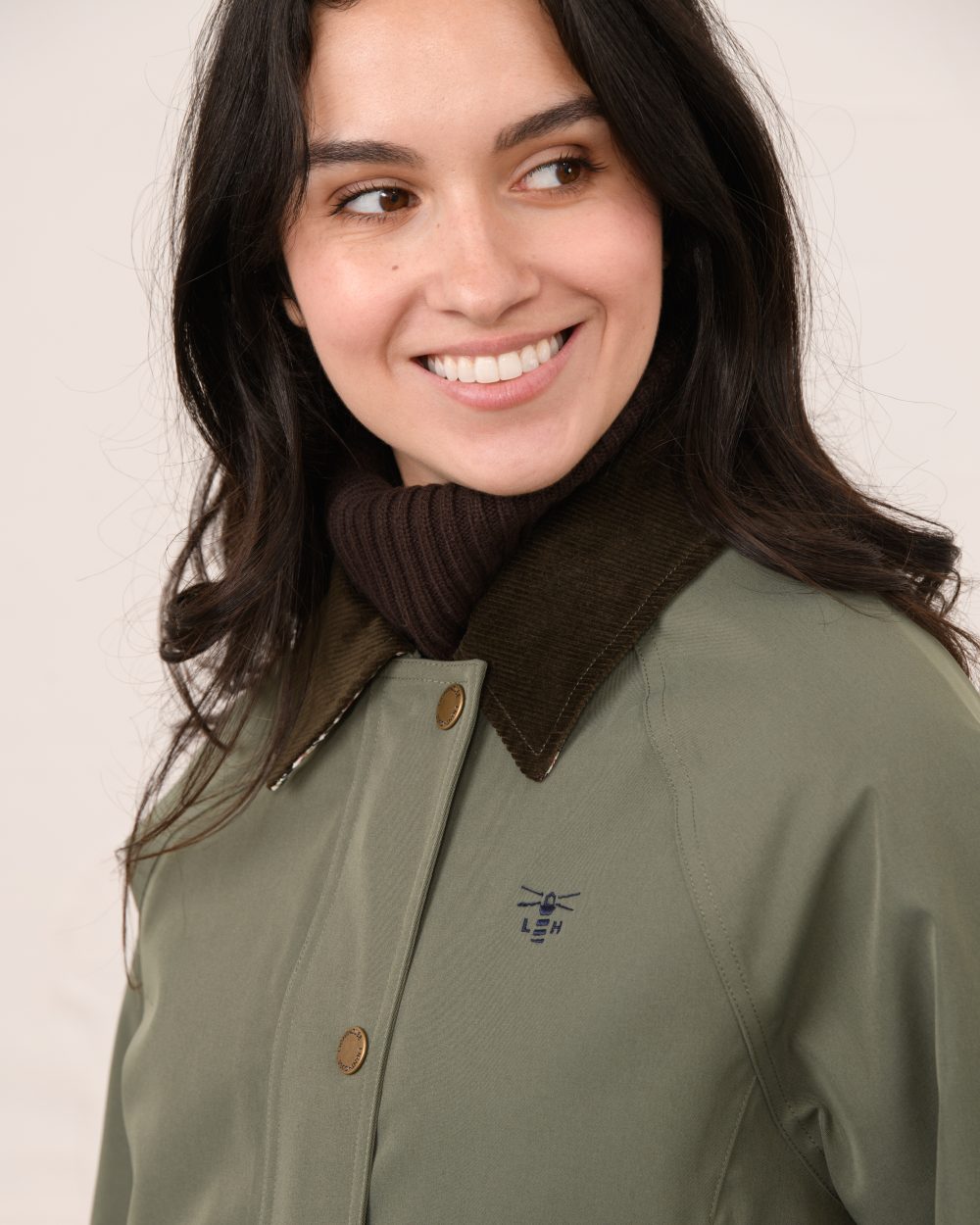 Olivine coloured Lighthouse Ladies Devon Raincoat on indoor background 