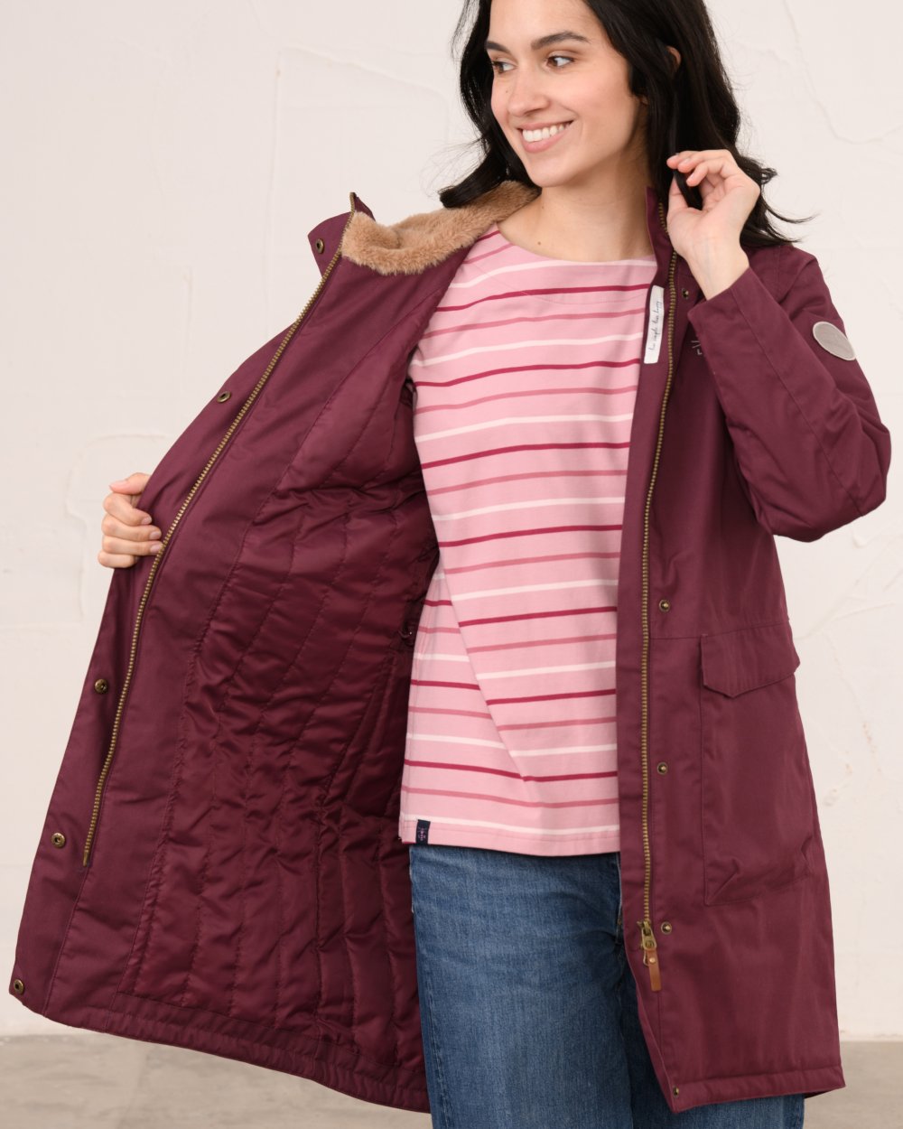Damson coloured Lighthouse Ladies Fallon Coat on wall background 