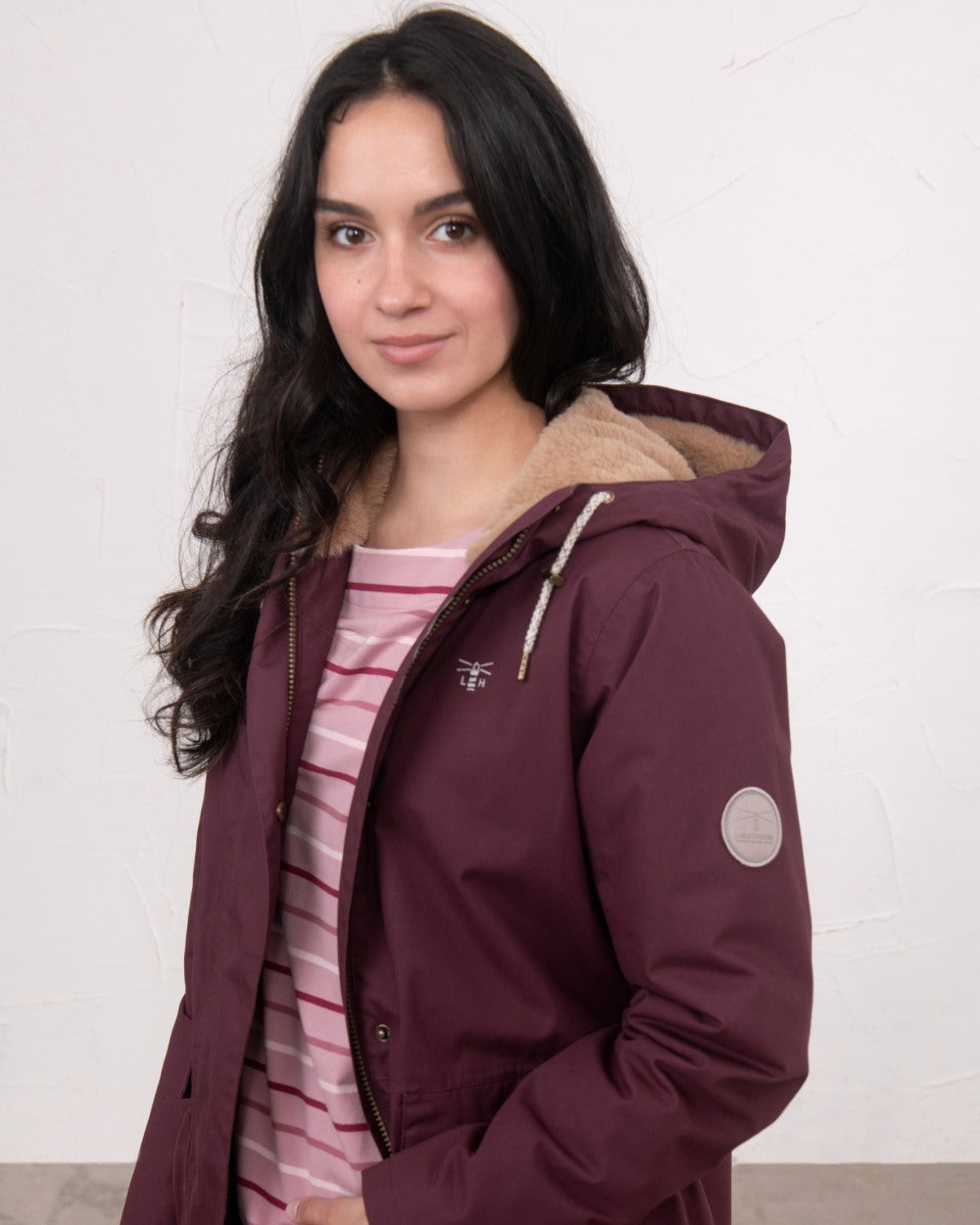 Damson coloured Lighthouse Ladies Fallon Coat on wall background 
