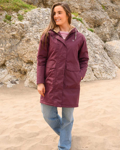 Damson coloured Lighthouse Ladies Fallon Coat on sand background 