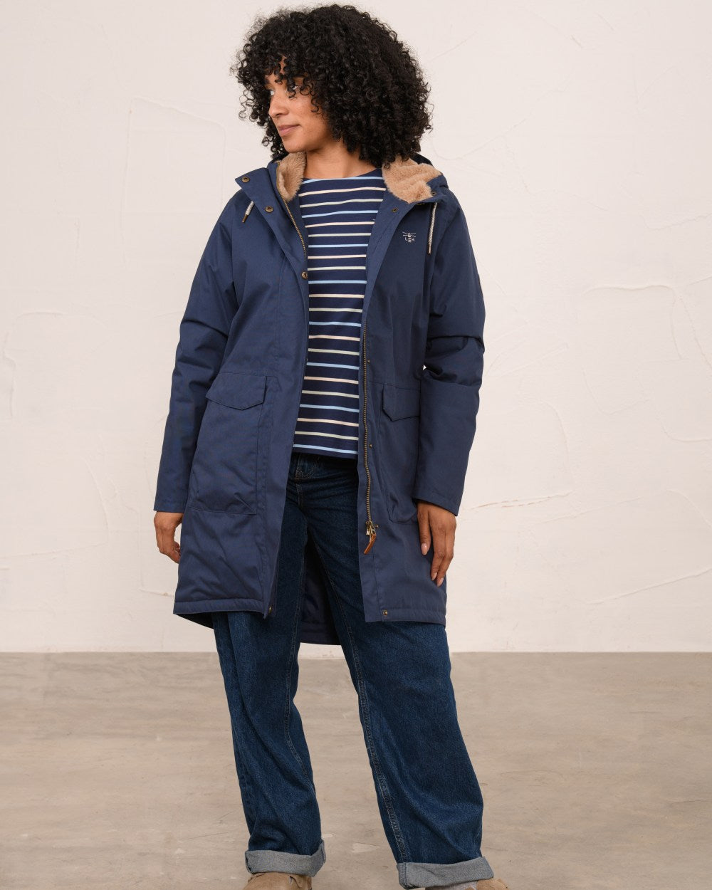 Navy coloured Lighthouse Ladies Fallon Coat on wall background 