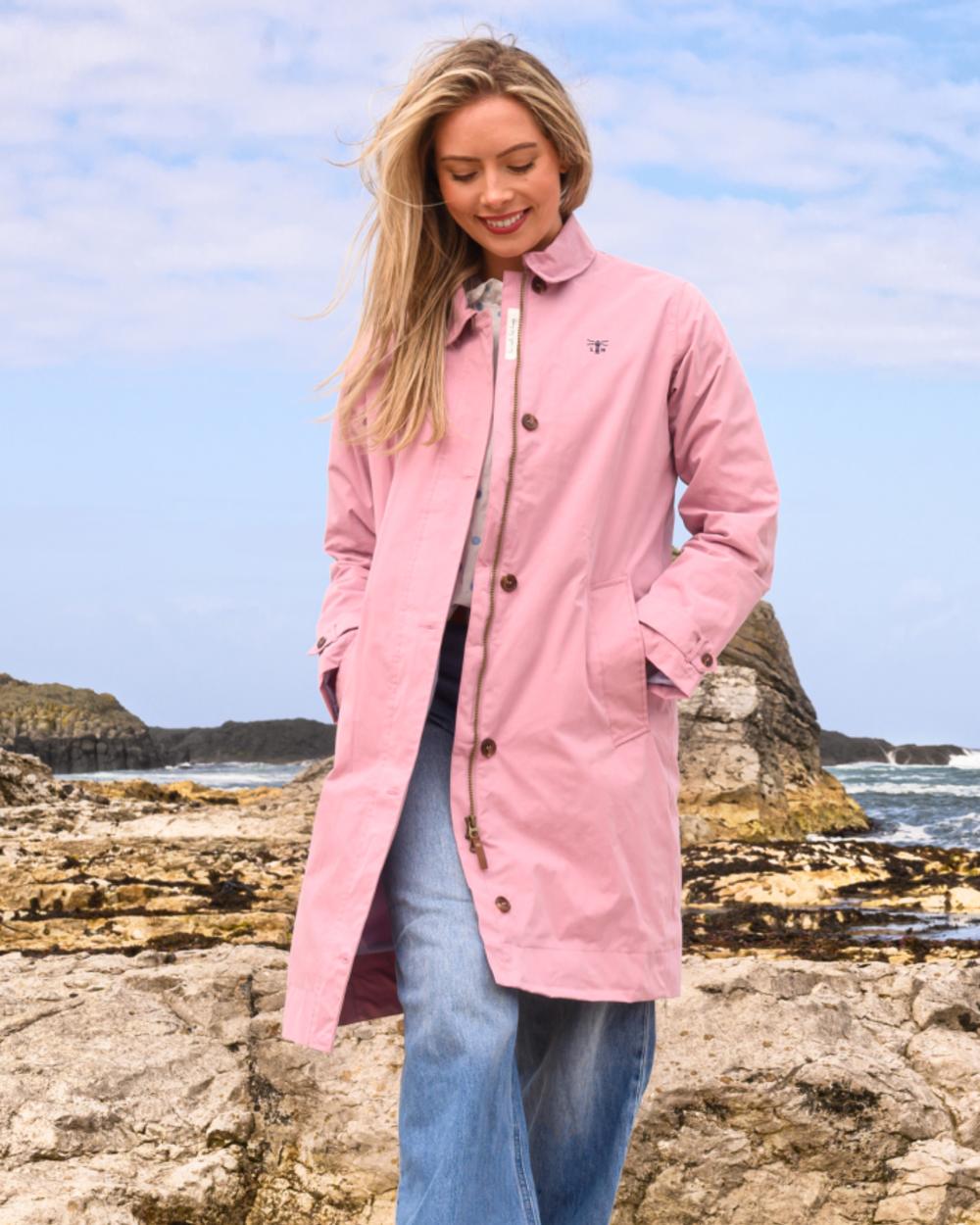 Wild Rose coloured Lighthouse Ladies Hallie Long Coat on beach background 