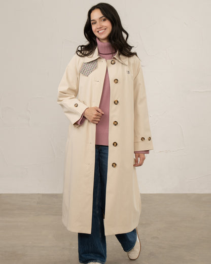 Stone coloured Lighthouse Ladies Harper Waterproof Trench Coat on wall background 
