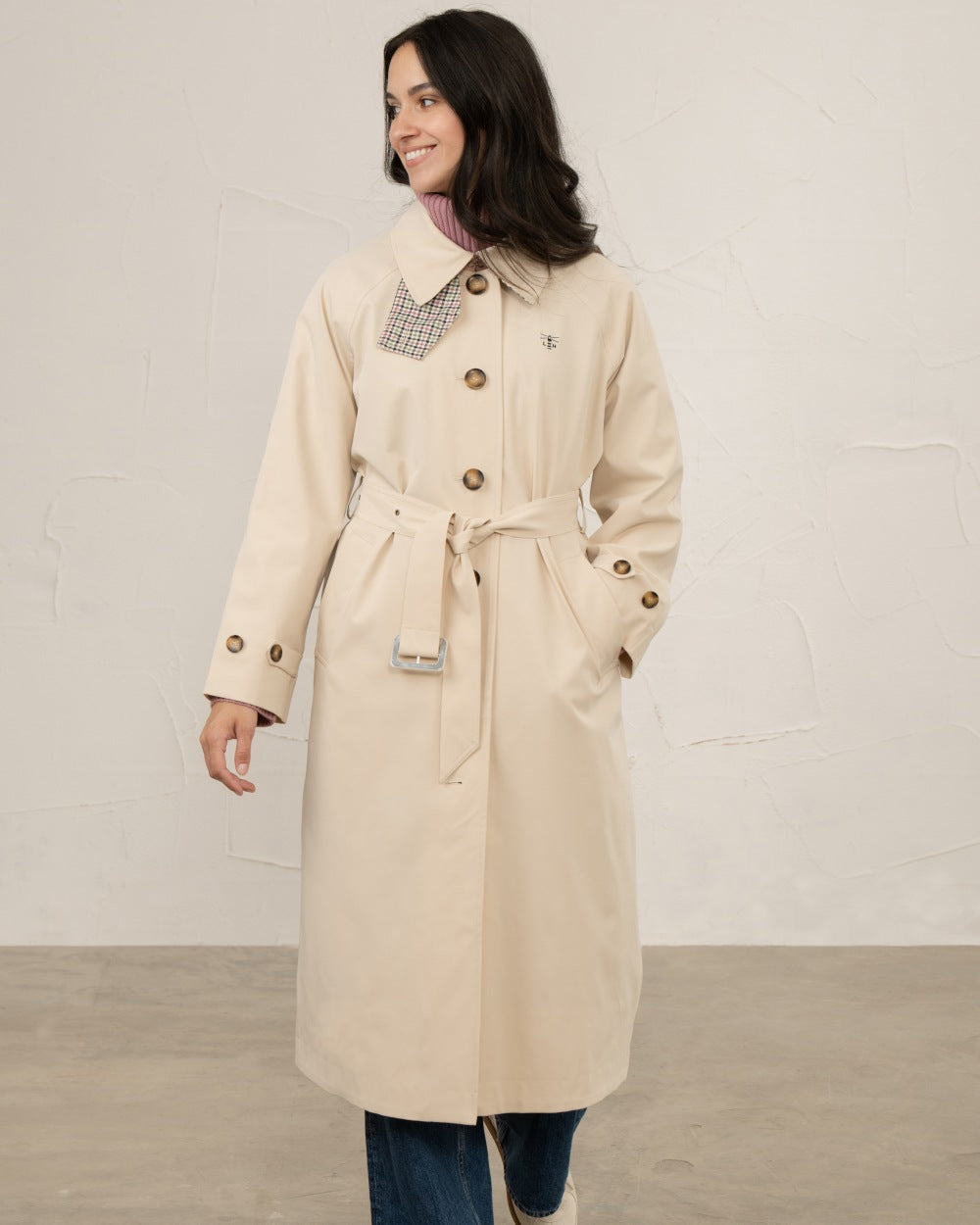 Stone coloured Lighthouse Ladies Harper Waterproof Trench Coat on wall background 