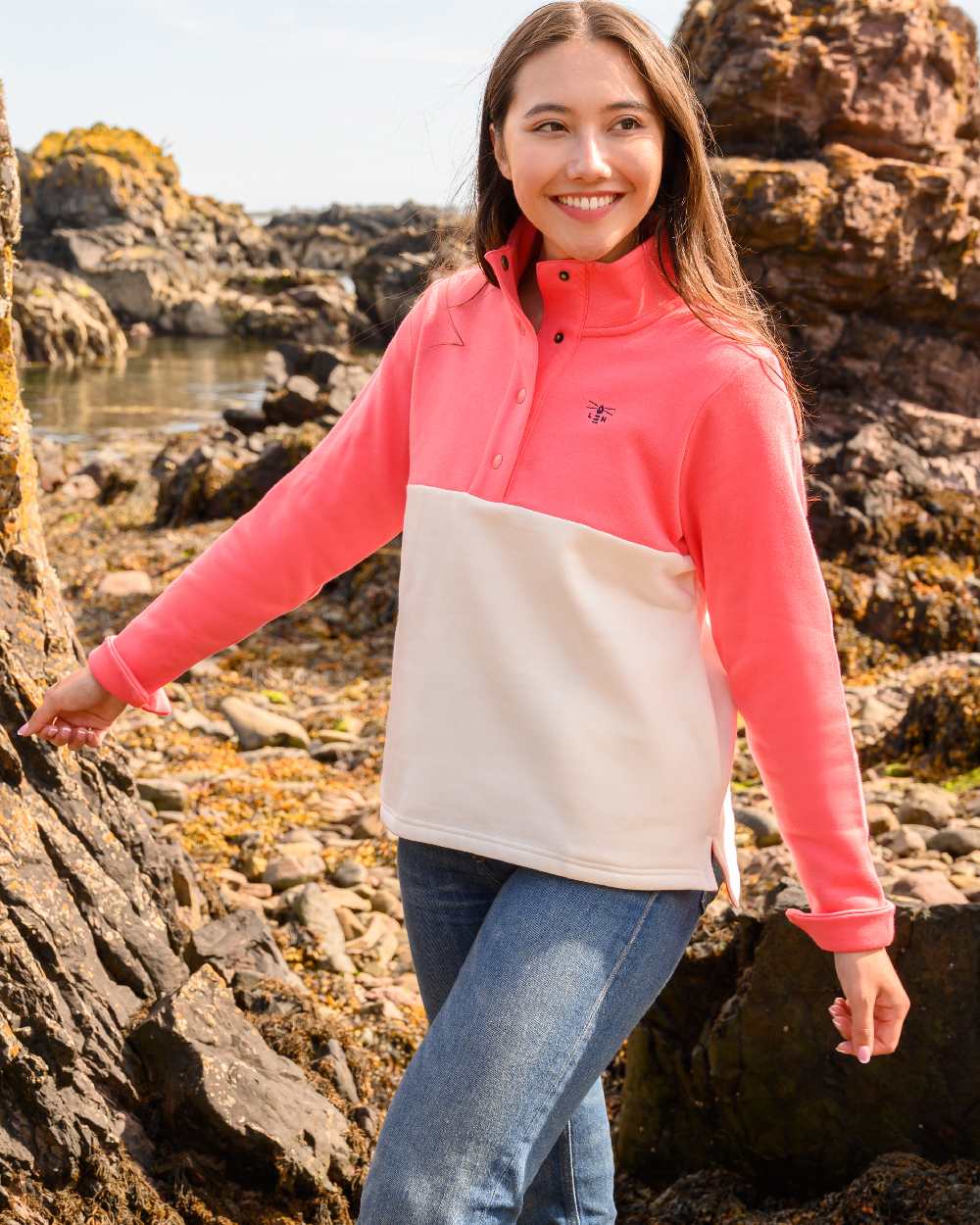 Coconut Deep Coral coloured Lighthouse Ladies Haven Jersey on cliff background 