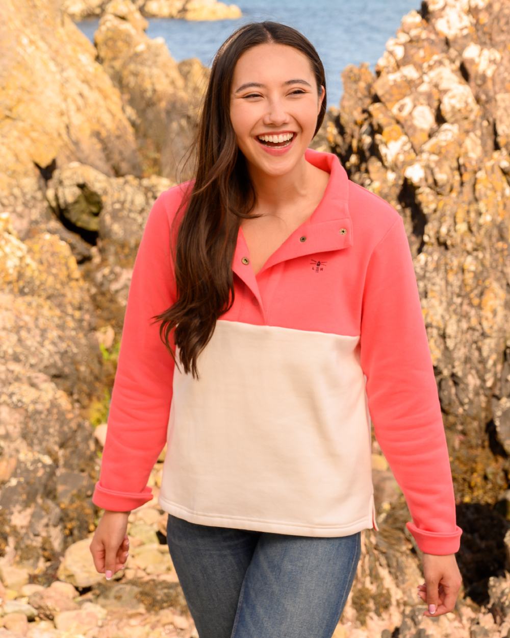 Coconut Deep Coral coloured Lighthouse Ladies Haven Jersey on cliff background 