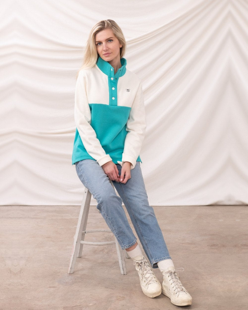 Coconut Soft Teal coloured Lighthouse Ladies Haven Jersey on curtain background 