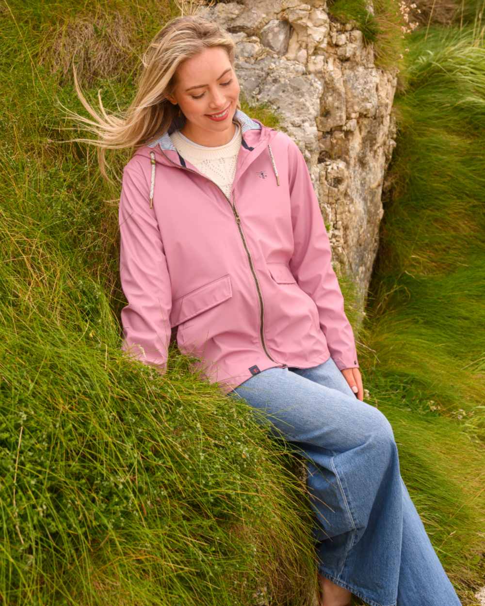 Wild Rose coloured Lighthouse Ladies Lucy Jacket on rock background 