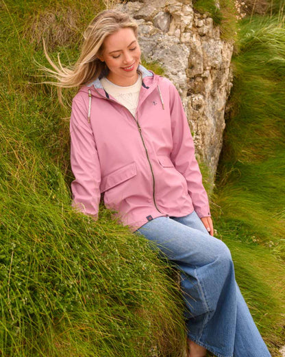 Wild Rose coloured Lighthouse Ladies Lucy Jacket on rock background 