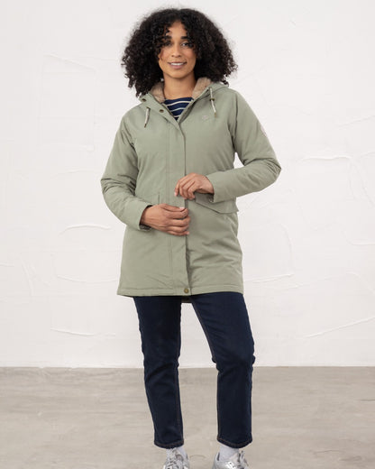 Brushwood coloured Lighthouse Ladies Scarlet Coat on wall background 