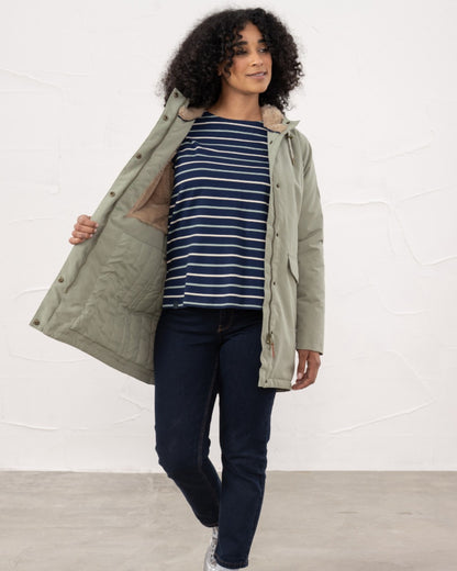 Brushwood coloured Lighthouse Ladies Scarlet Coat on wall background 