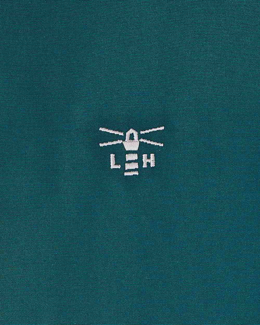 Pine coloured Lighthouse Ladies Scarlet Coat on wall background 