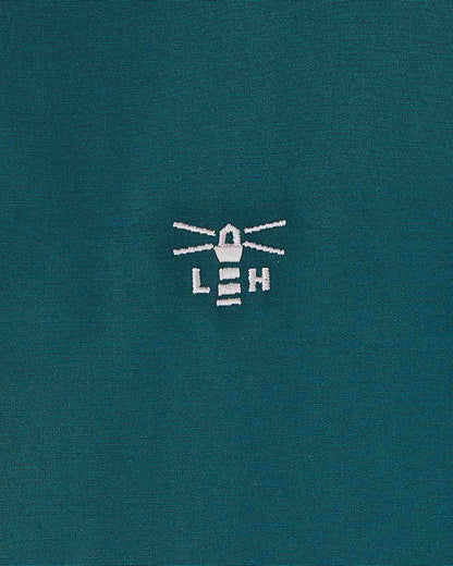 Pine coloured Lighthouse Ladies Scarlet Coat on wall background 