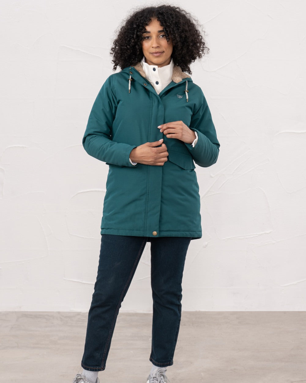 Pine coloured Lighthouse Ladies Scarlet Coat on wall background 