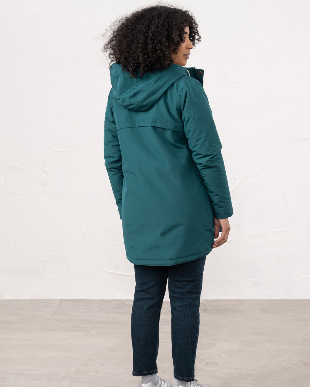 Pine coloured Lighthouse Ladies Scarlet Coat on wall background 