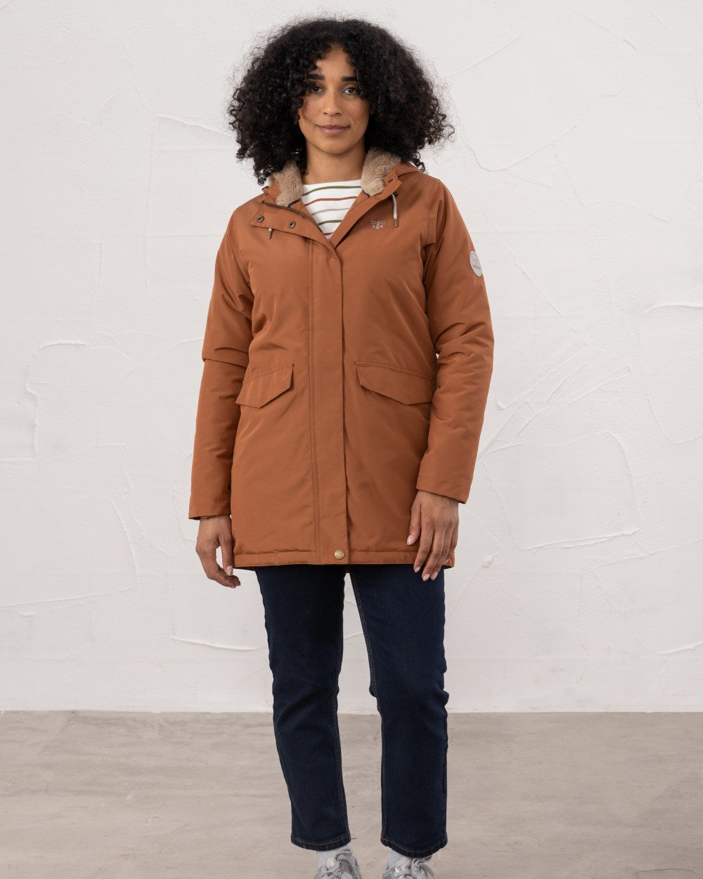 Rust coloured Lighthouse Ladies Scarlet Coat on wall background 