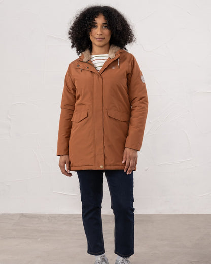 Rust coloured Lighthouse Ladies Scarlet Coat on wall background 