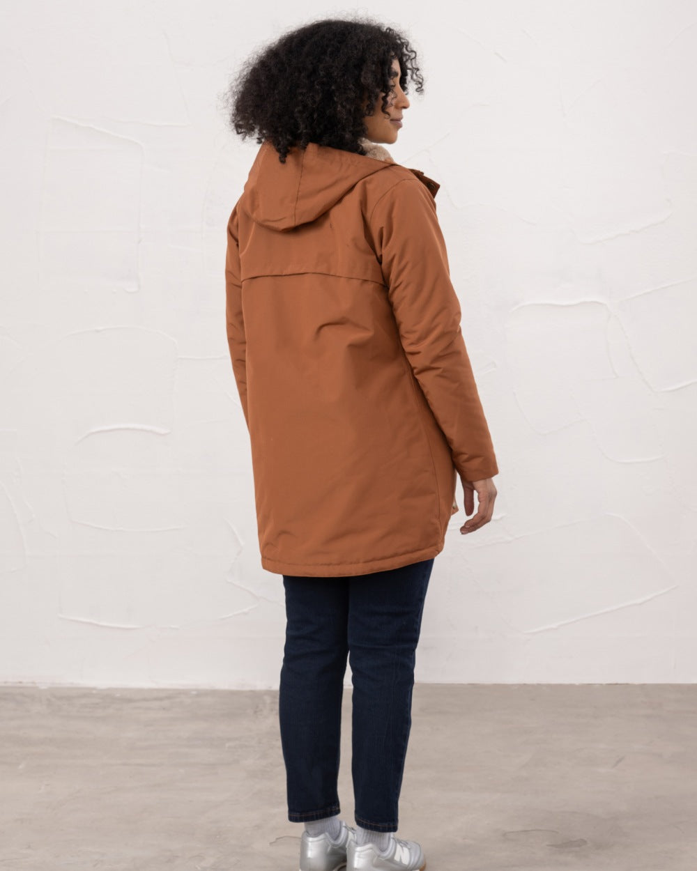 Rust coloured Lighthouse Ladies Scarlet Coat on wall background 
