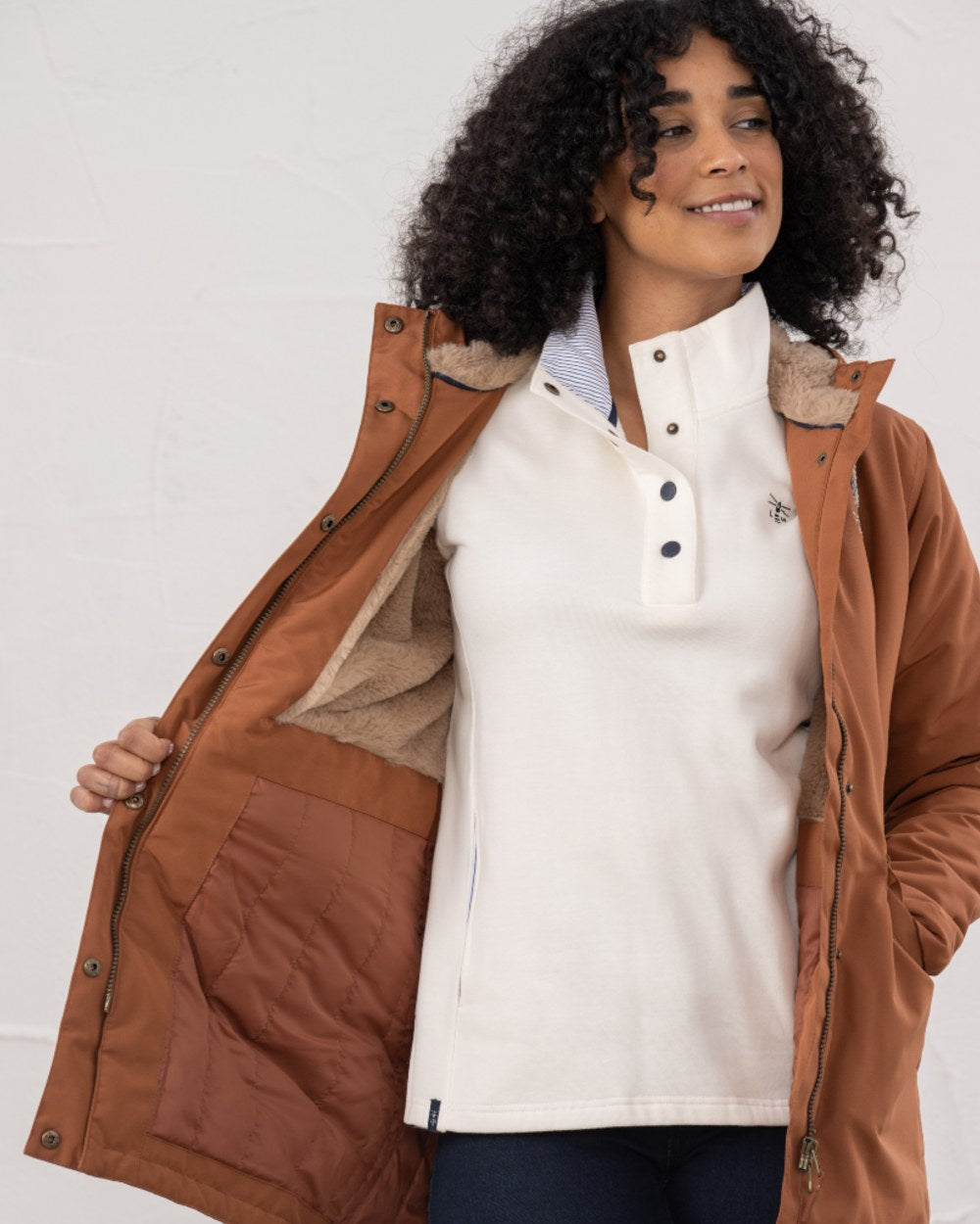Rust coloured Lighthouse Ladies Scarlet Coat on wall background 