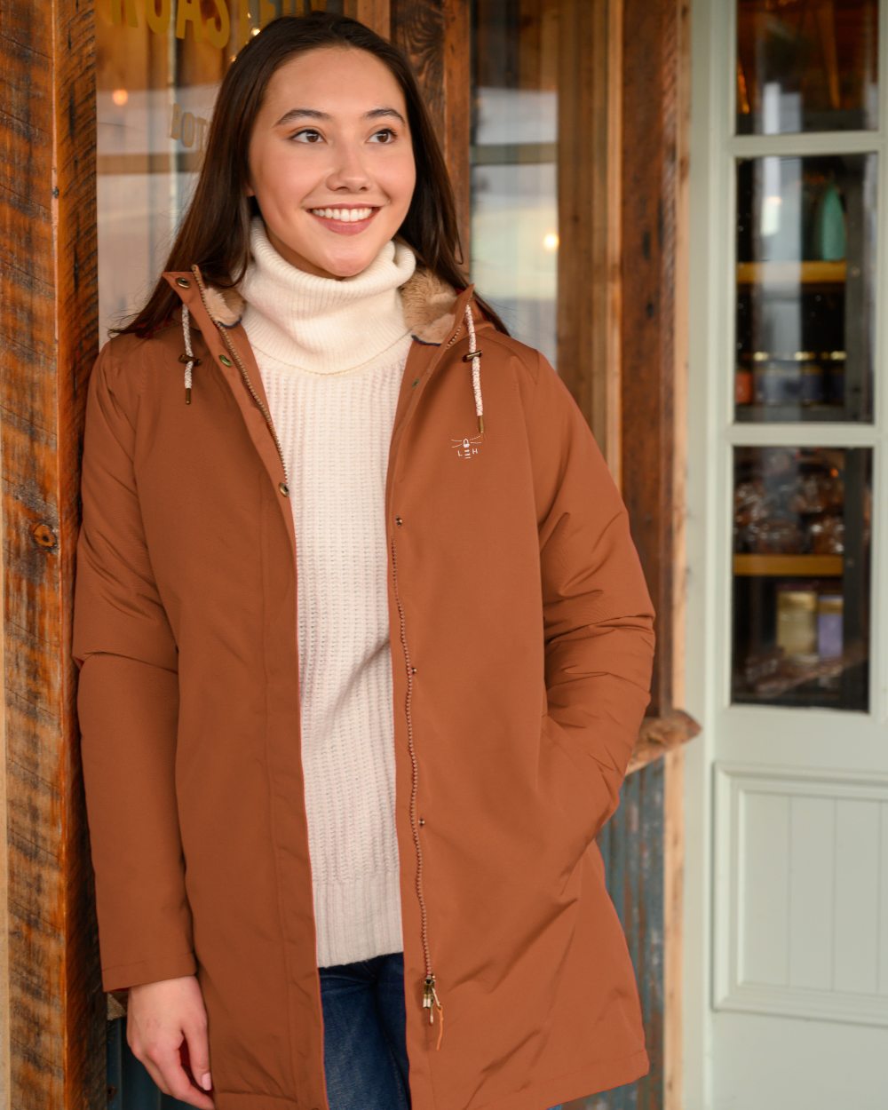 Rust coloured Lighthouse Ladies Scarlet Coat on house background 