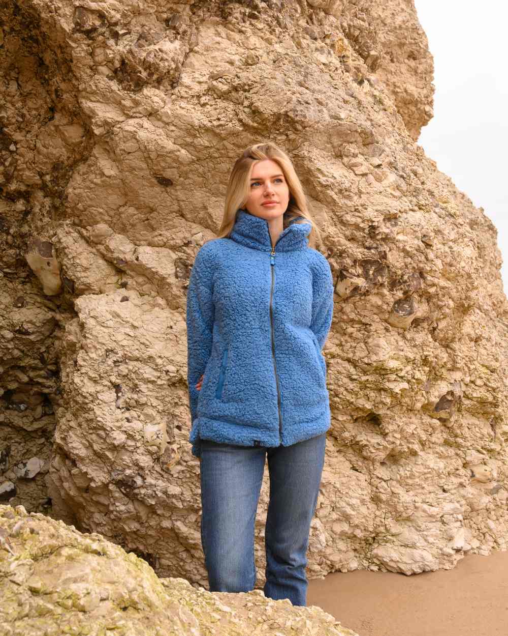 Marine Blue coloured Lighthouse Ladies Seashell Full Zip Sherpa Fleece on rock background 