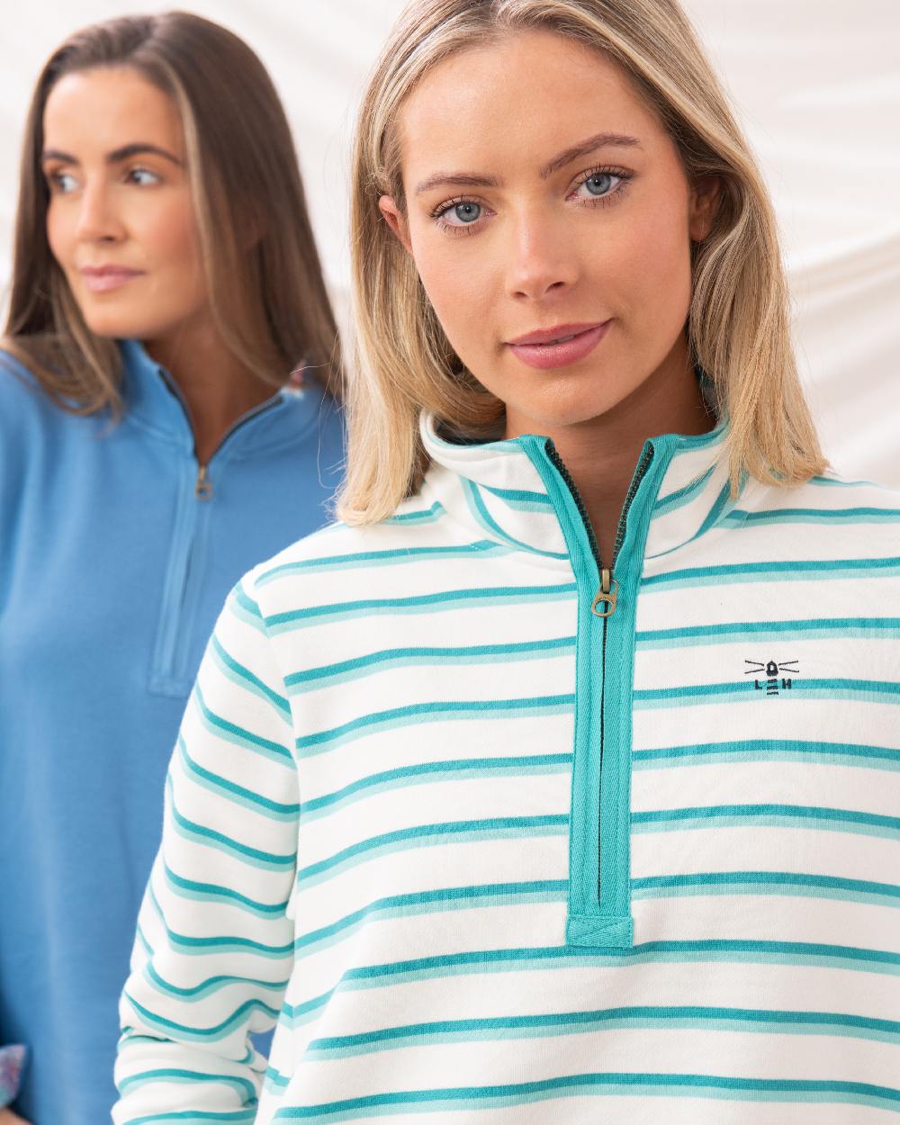 Soft Teal Stripe coloured Lighthouse Ladies Shore Sweatshirt on curtain background 