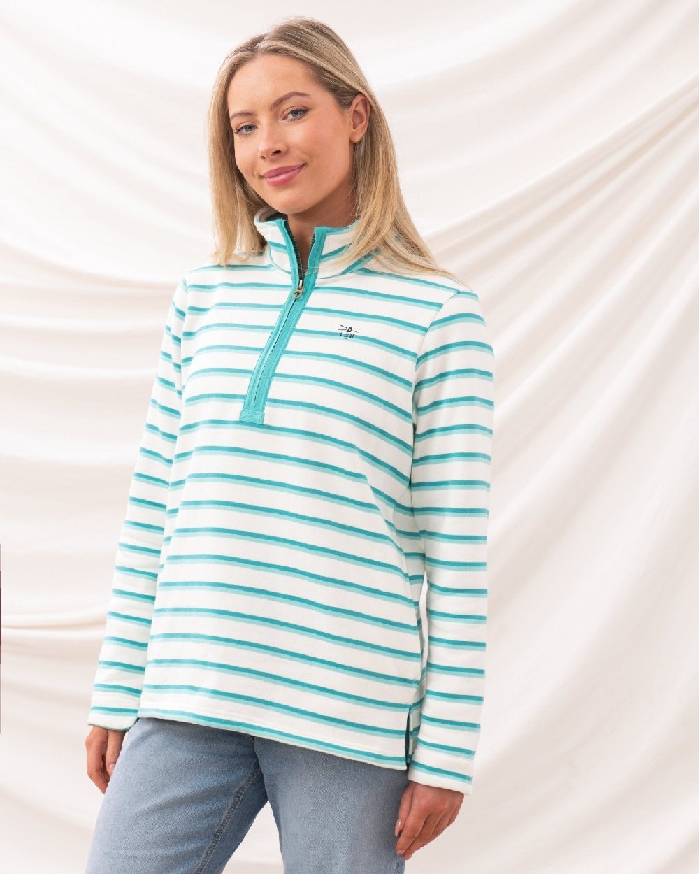 Soft Teal Stripe coloured Lighthouse Ladies Shore Sweatshirt on curtain background 