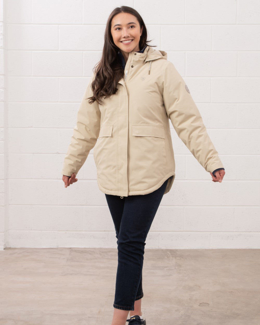 Cream coloured Lighthouse Ladies Tess Coat on wall background 