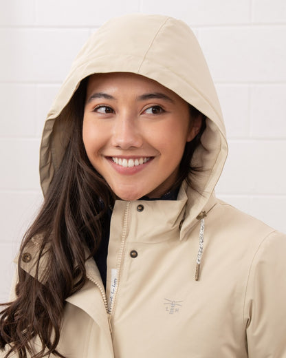 Cream coloured Lighthouse Ladies Tess Coat on wall background 