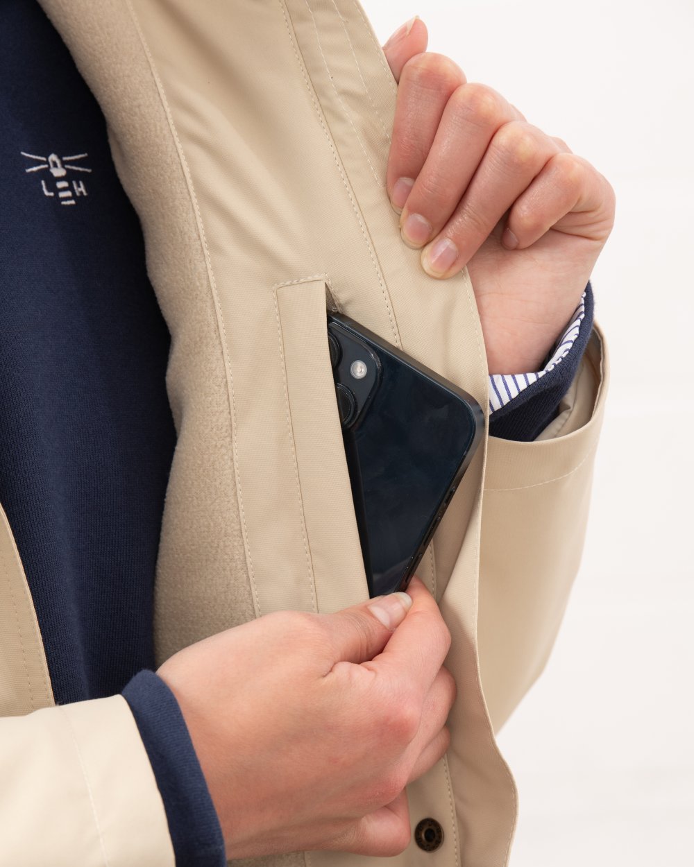 Cream coloured Lighthouse Ladies Tess Coat on wall background 