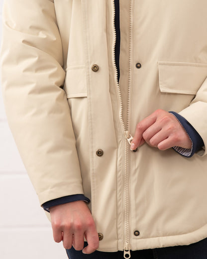 Cream coloured Lighthouse Ladies Tess Coat on wall background 