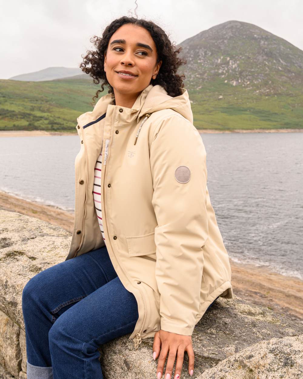 Cream coloured Lighthouse Ladies Tess Coat on sea background 