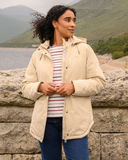 Cream coloured Lighthouse Ladies Tess Coat on sea background 