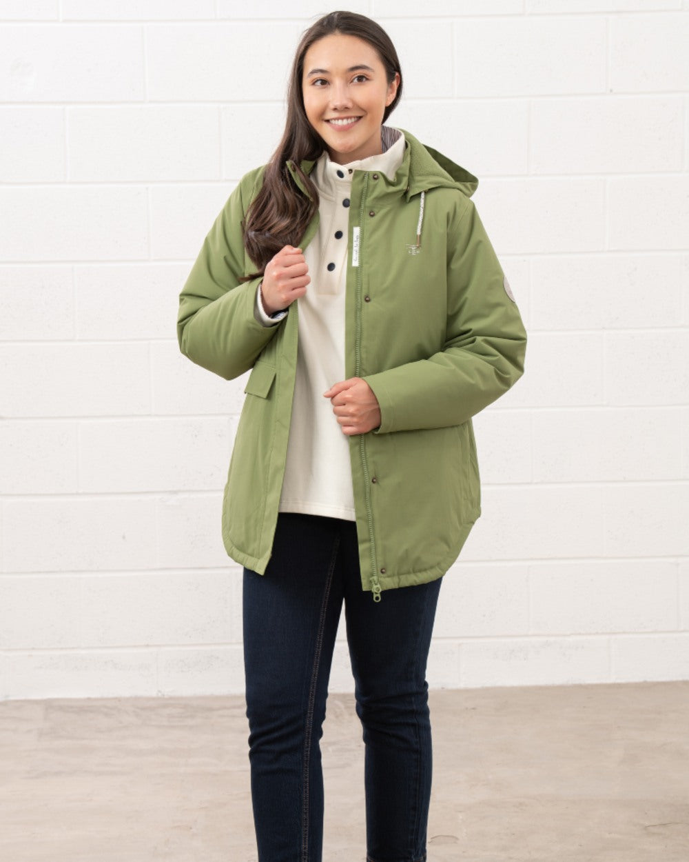 Sea Kelp coloured Lighthouse Ladies Tess Coat on wall background 