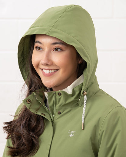 Sea Kelp coloured Lighthouse Ladies Tess Coat on wall background 