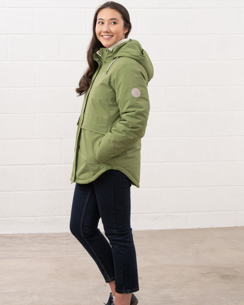 Sea Kelp coloured Lighthouse Ladies Tess Coat on wall background 