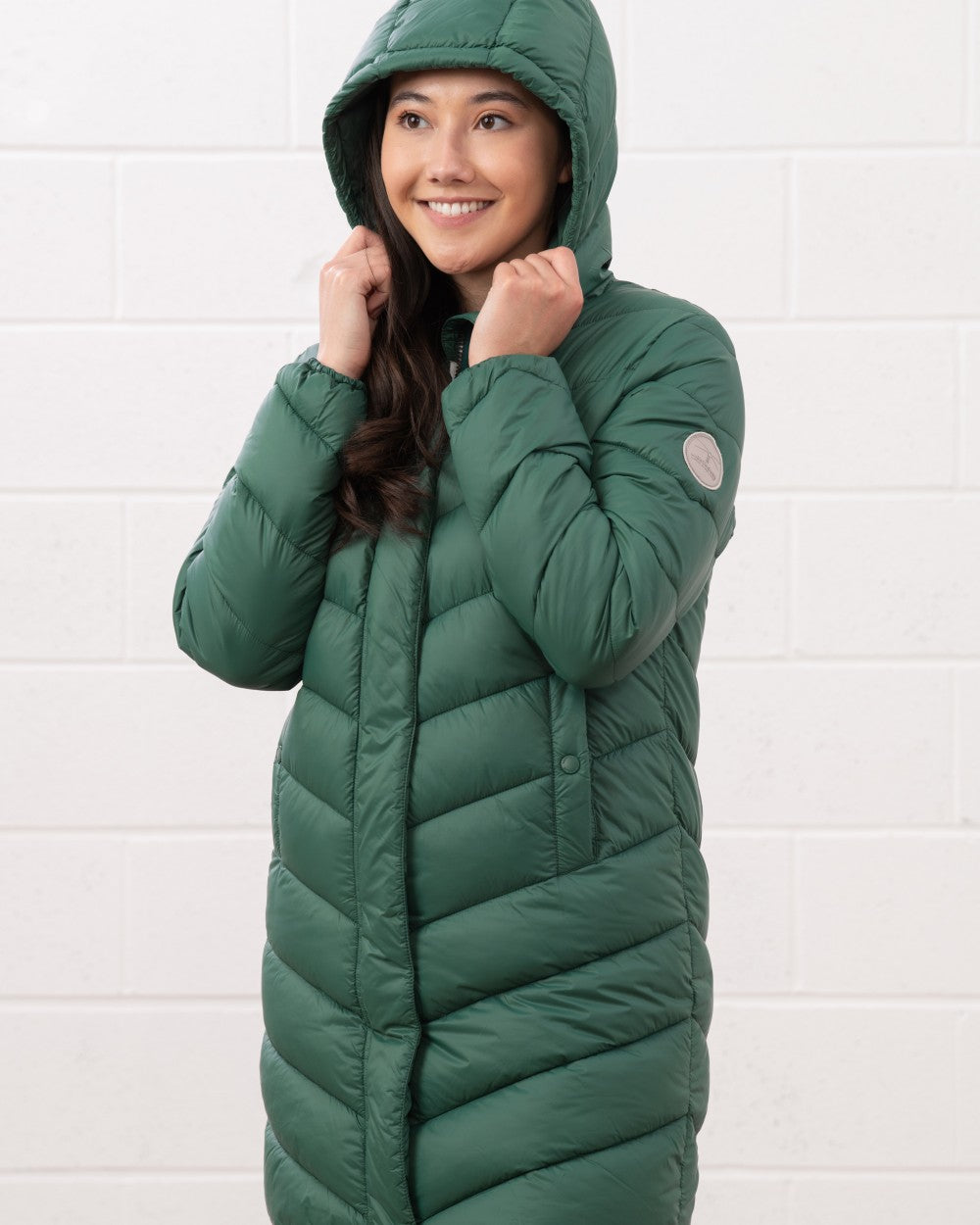 Kale coloured Lighthouse Laurel Ladies Coat on wall background 