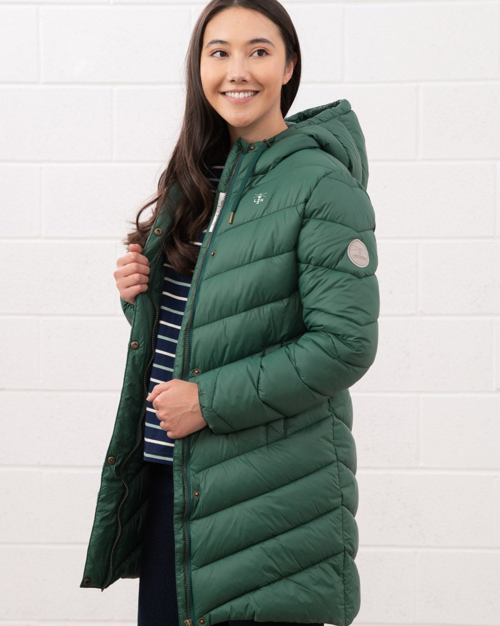 Kale coloured Lighthouse Laurel Ladies Coat on wall background 