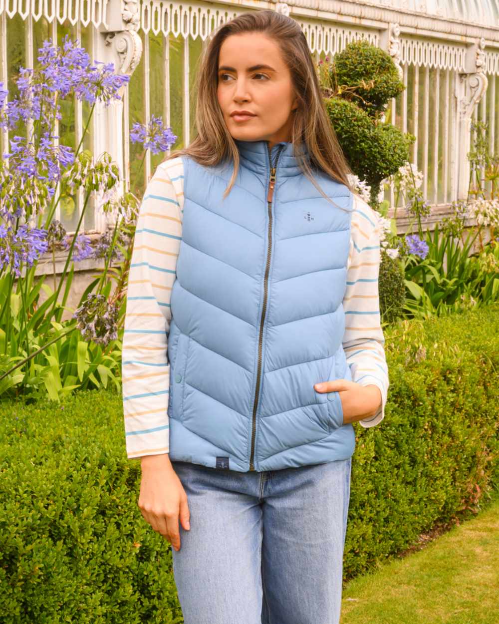 Blue coloured Lighthouse Laurel Ladies Gilet on garden background 