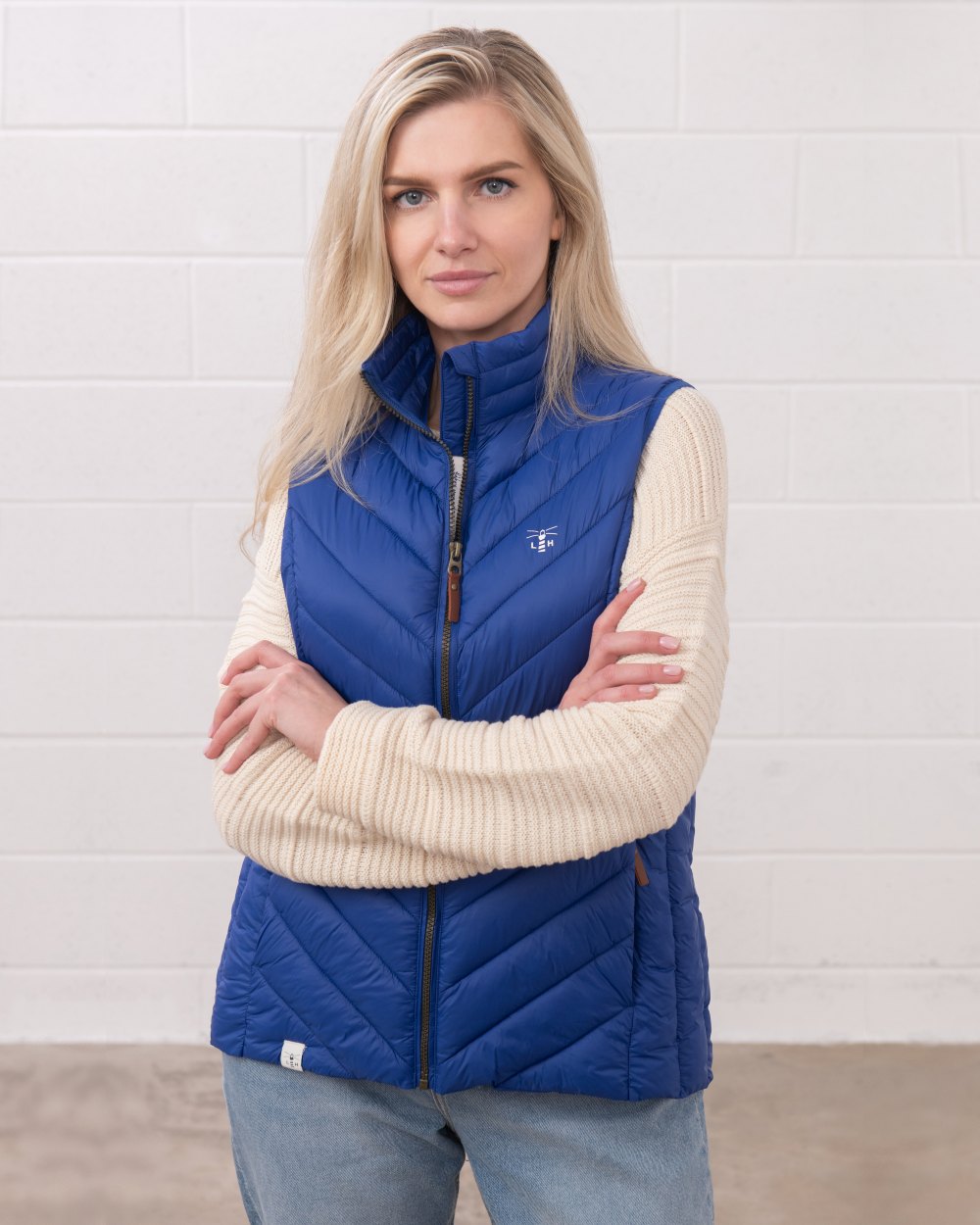 Indigo coloured Lighthouse Laurel Ladies Gilet on wall background 
