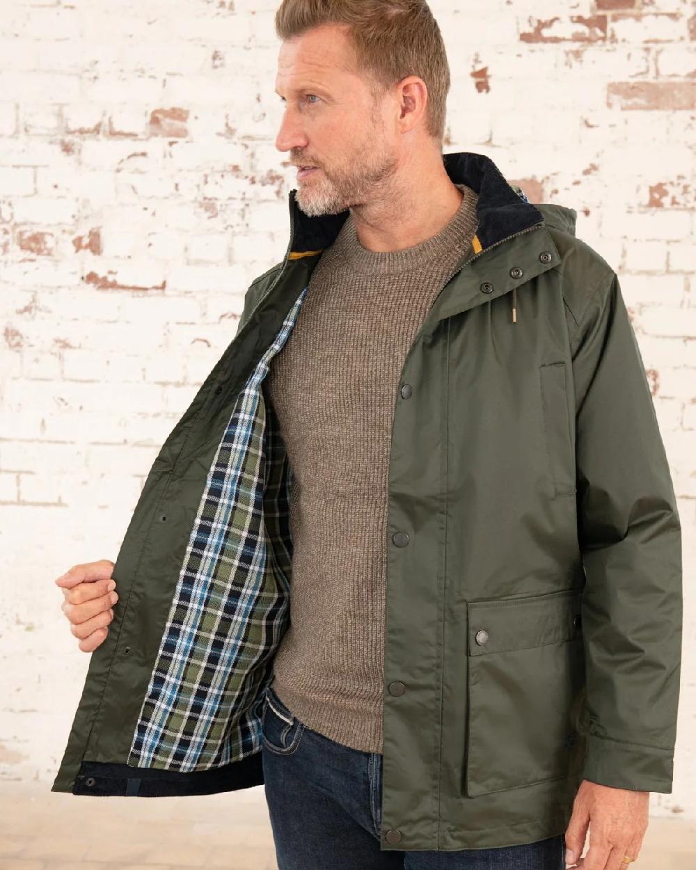 Hunter Green Coloured Lighthouse Mens Oxford Raincoat on wall background 
