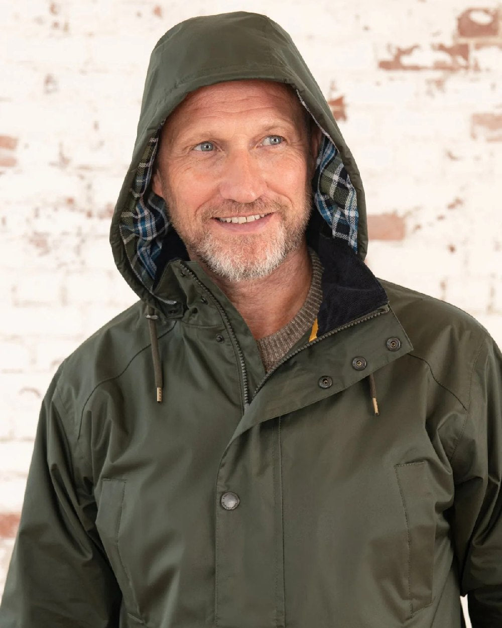 Hunter Green Coloured Lighthouse Mens Oxford Raincoat on wall background 
