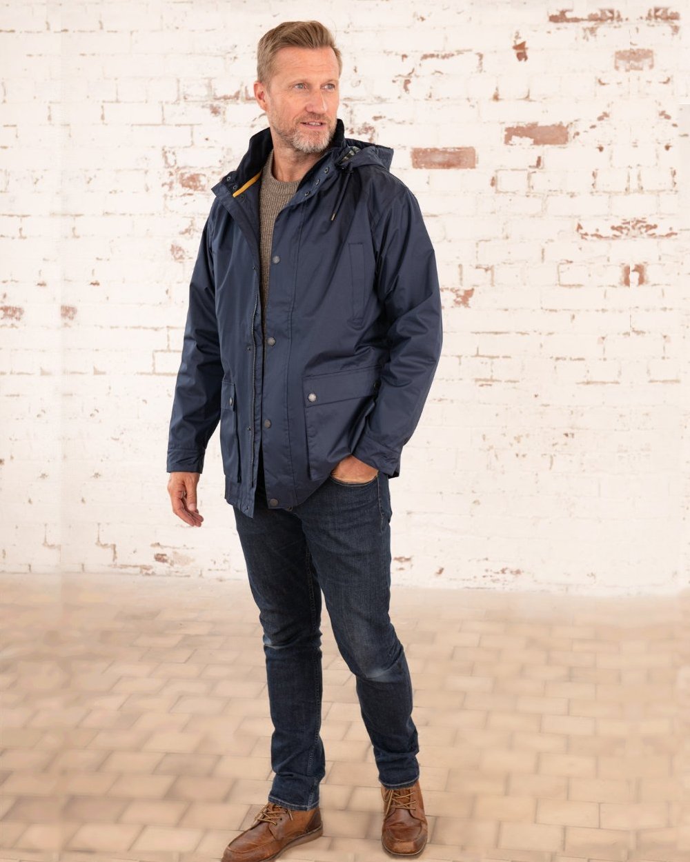 Navy coloured Lighthouse Mens Oxford Raincoat on wall background 