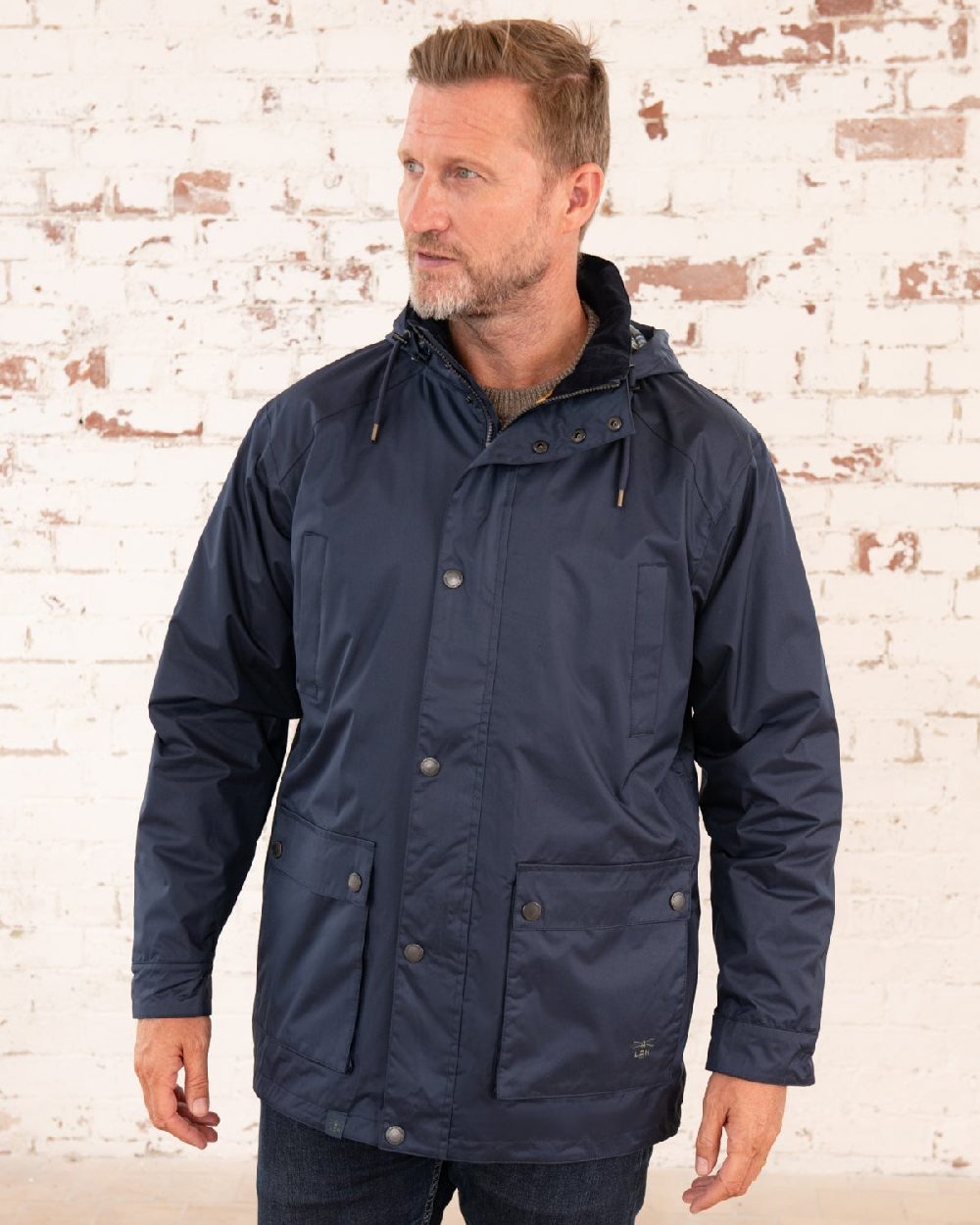 Navy coloured Lighthouse Mens Oxford Raincoat on wall background 