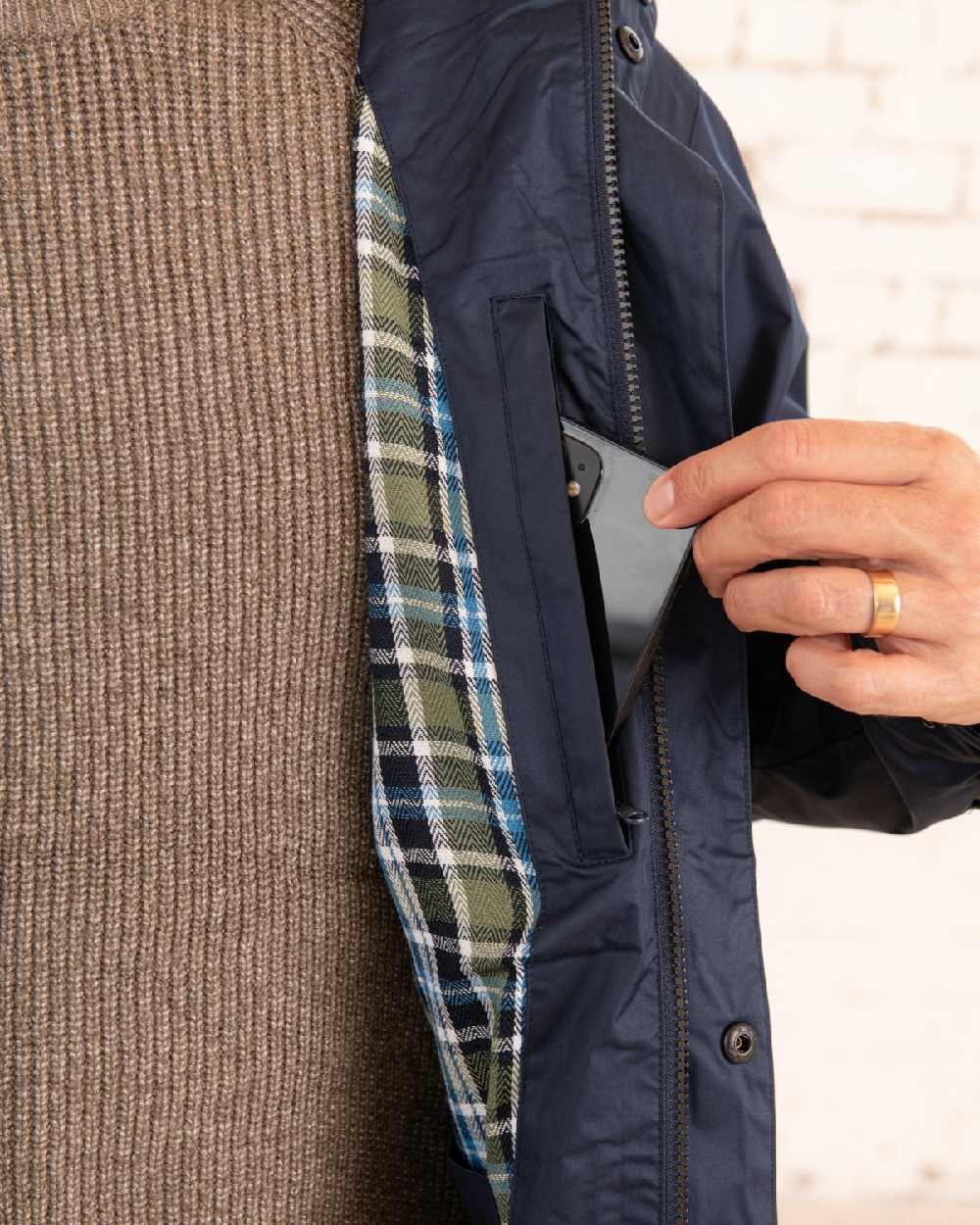 Navy coloured Lighthouse Mens Oxford Raincoat on wall background 