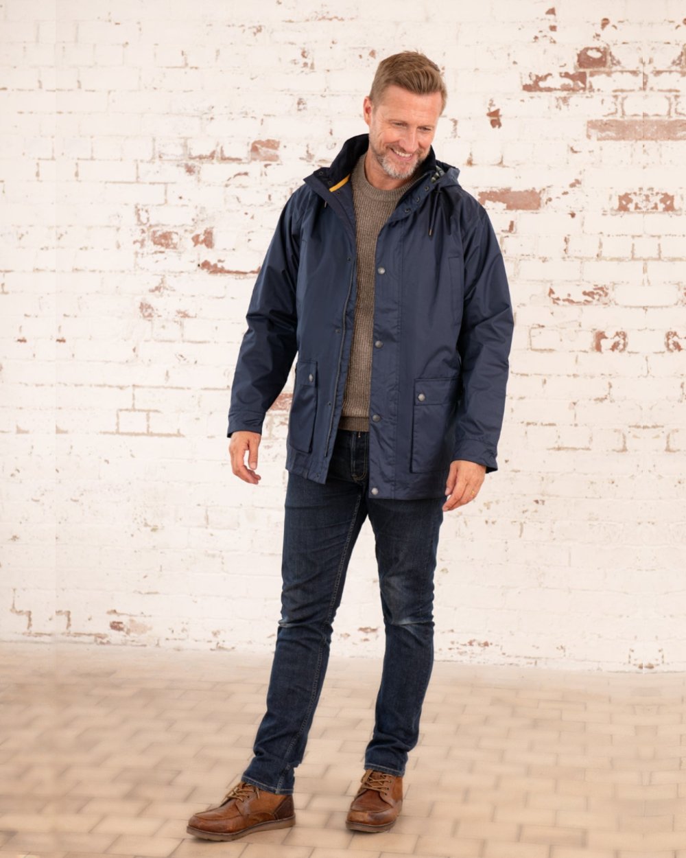 Navy coloured Lighthouse Mens Oxford Raincoat on wall background 