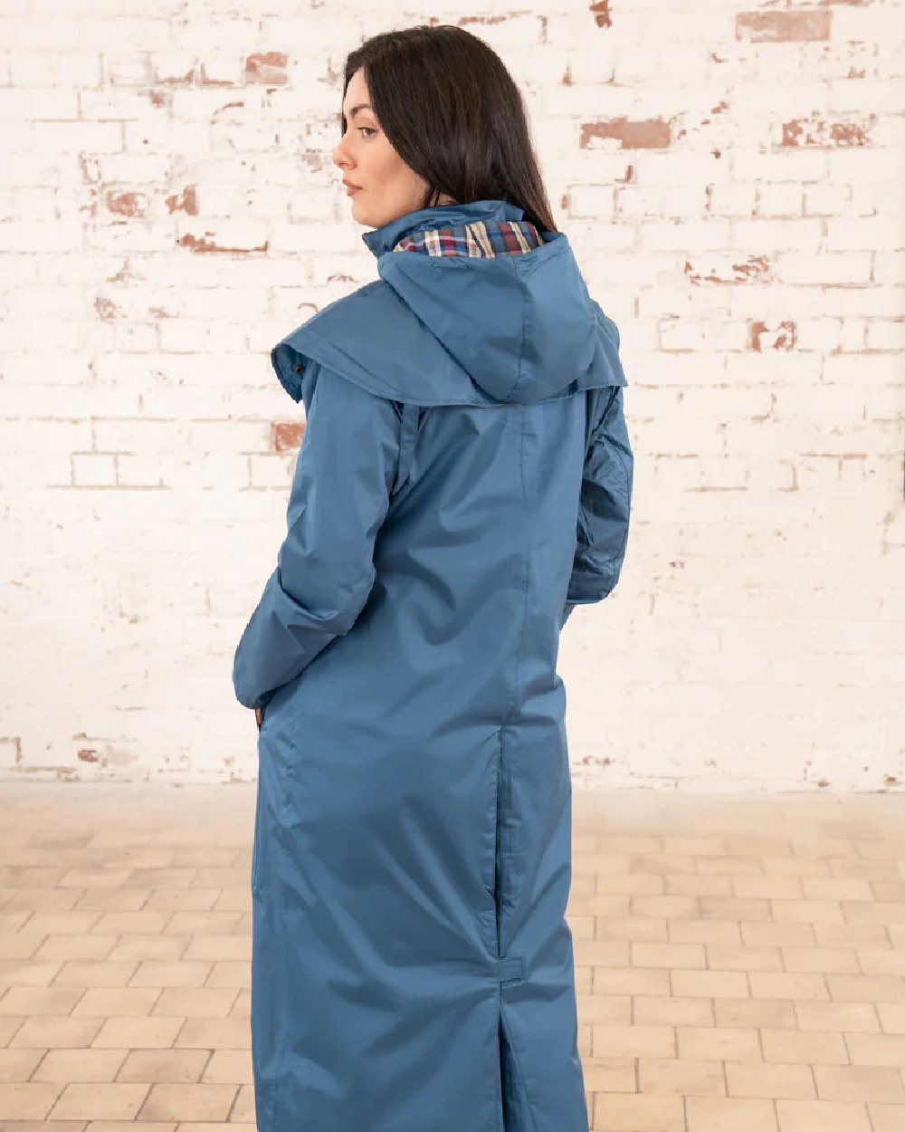 Deep Sea coloured Lighthouse Outback Full Length Ladies Waterproof Raincoat on wall background 