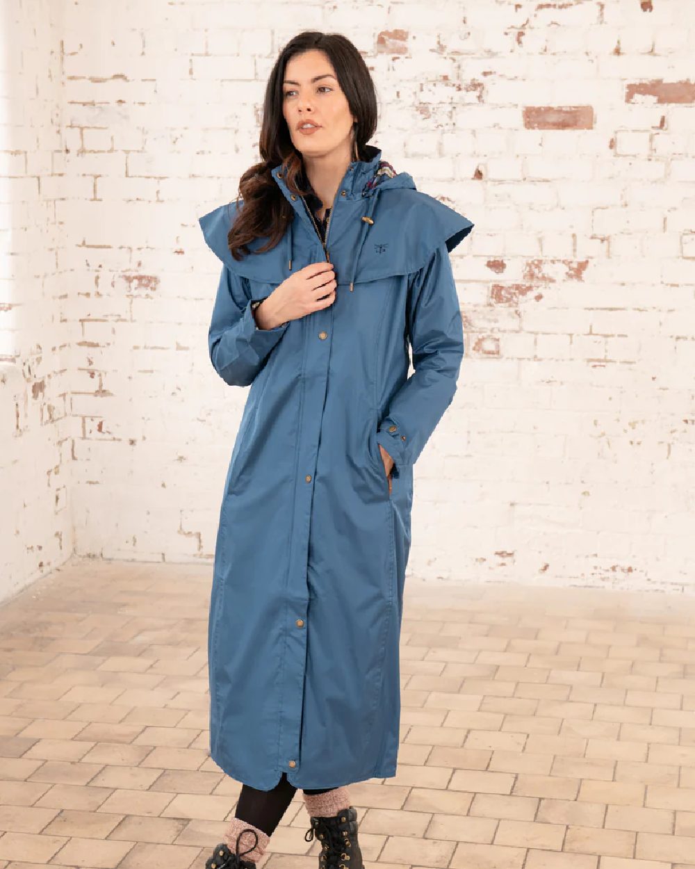 Deep Sea coloured Lighthouse Outback Full Length Ladies Waterproof Raincoat on wall background 