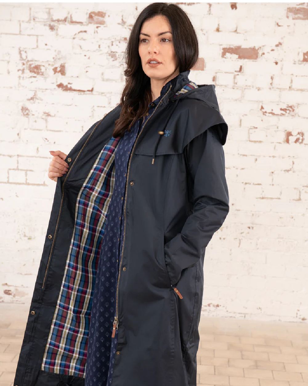 Nightshade coloured Lighthouse Outback Full Length Ladies Waterproof Raincoat on wall background 